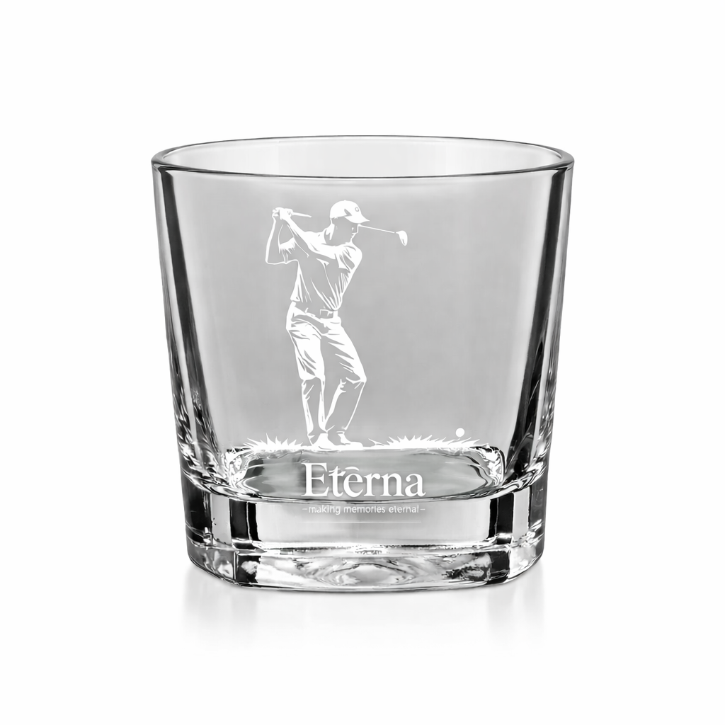 a short glass with an image etching of a man playing golf and text, Eterna Customs