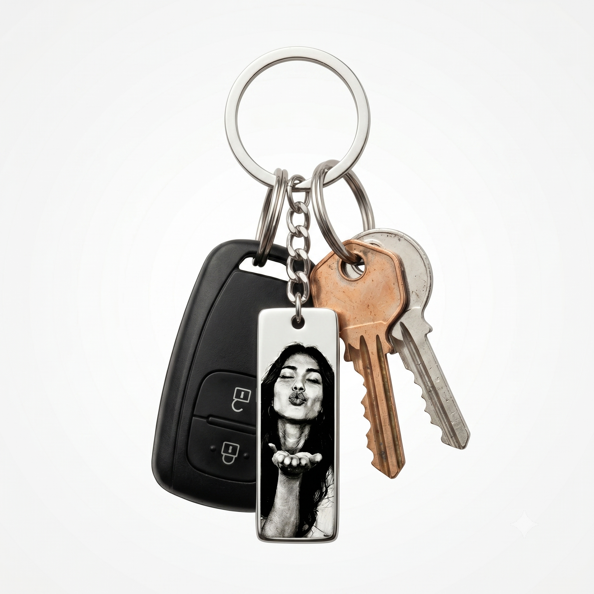 a keychain featuring a photo of a woman blowing a kiss, on a key ring with assorted house keys and car keys