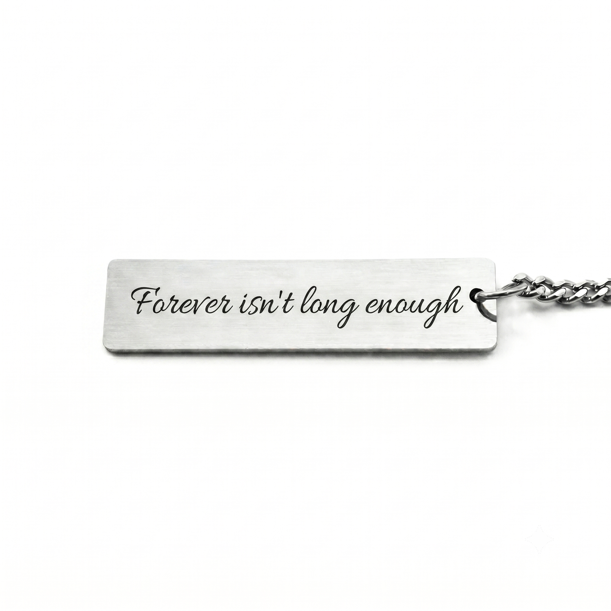 custom text on the back of a forever kissed pendant that reads "forever isn't long enough"
