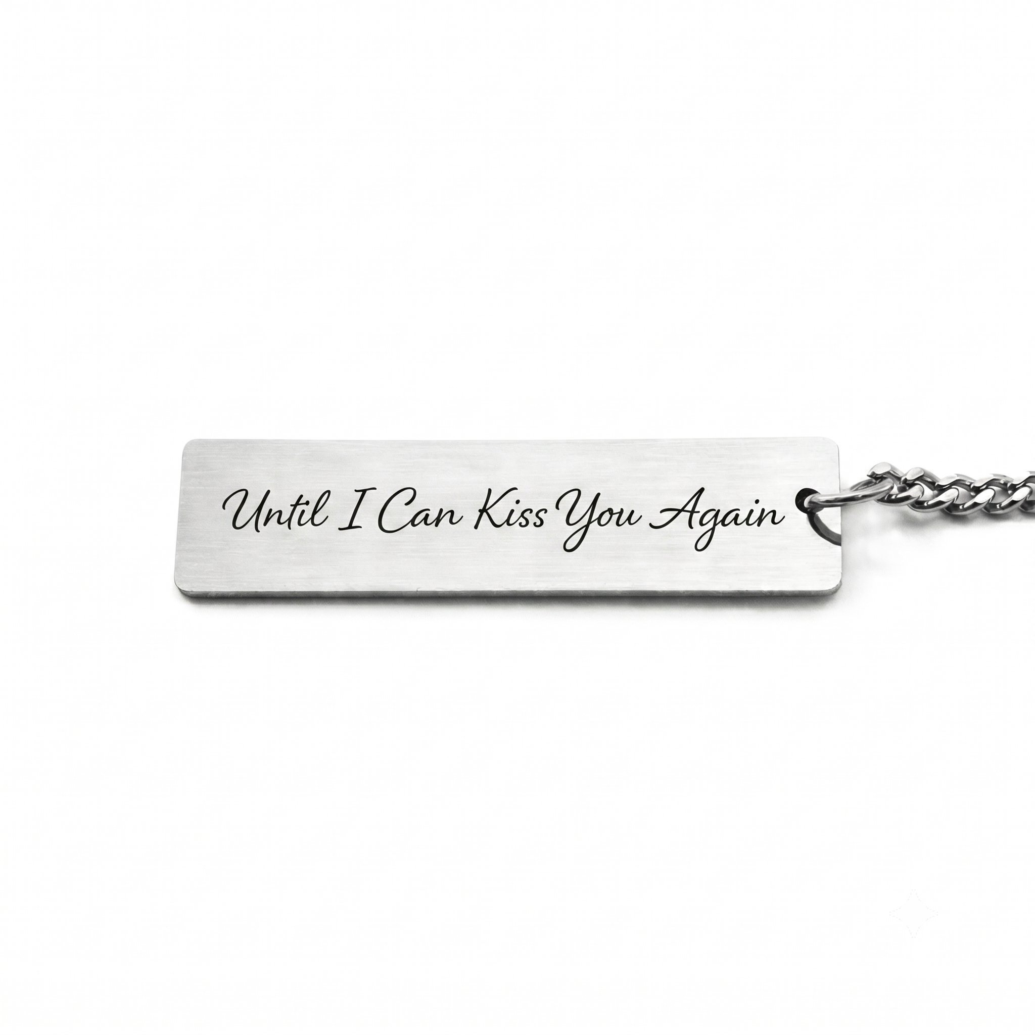 custom text on the back of a pendant in a casual script font that reads "until i can kiss you again"