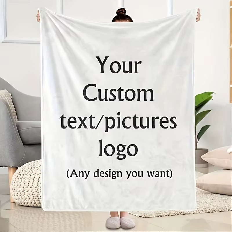 a woman holding up a blanket that is white and has sample text, "your custom text/pictures/logo (any design you want)"