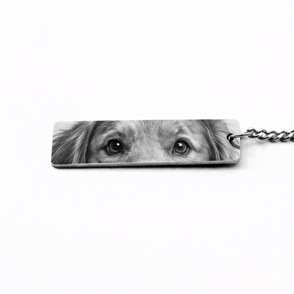 a silver keychain pendant featuring the eyes of a puppy in black and white