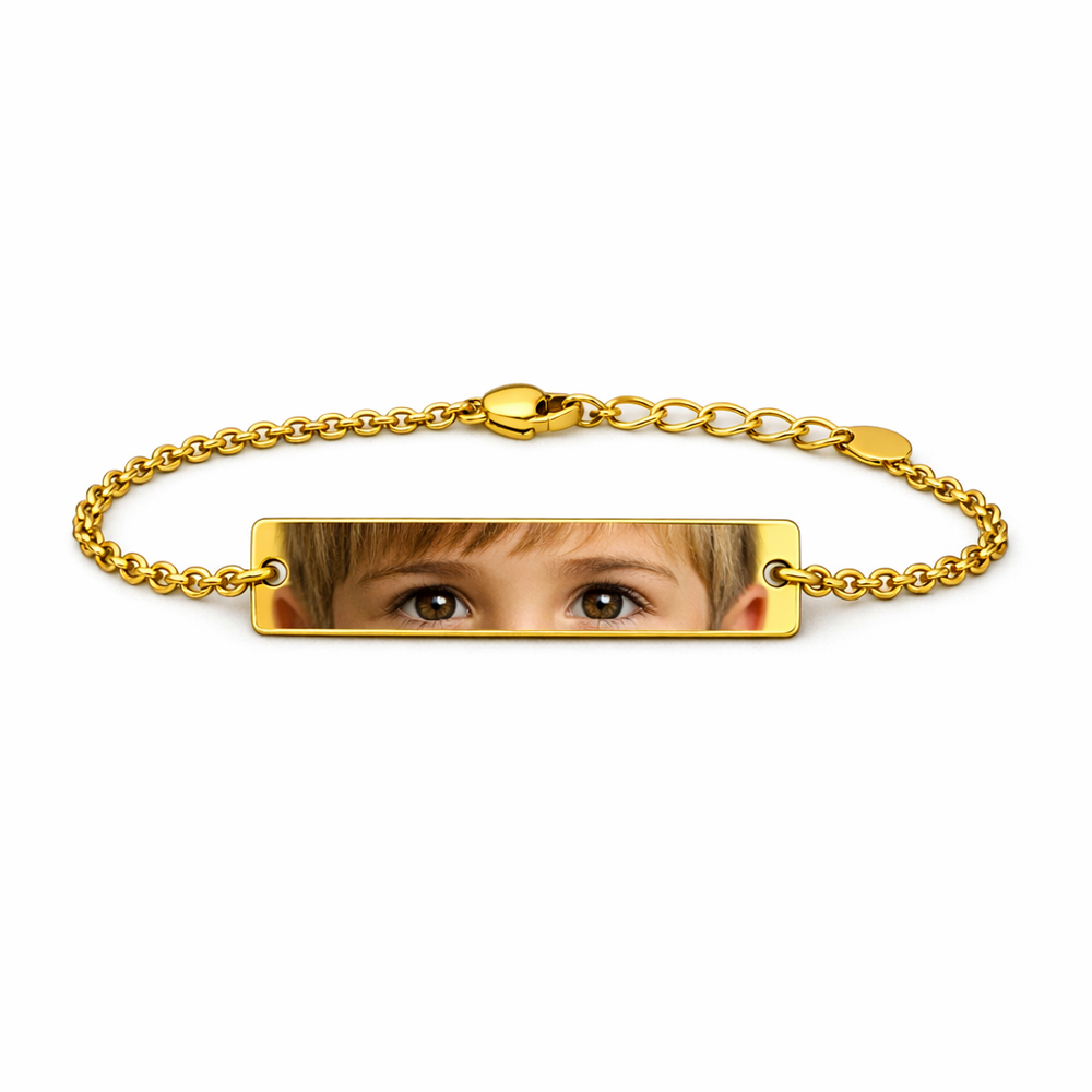 a gold bracelet featuring the image of a child's eyes