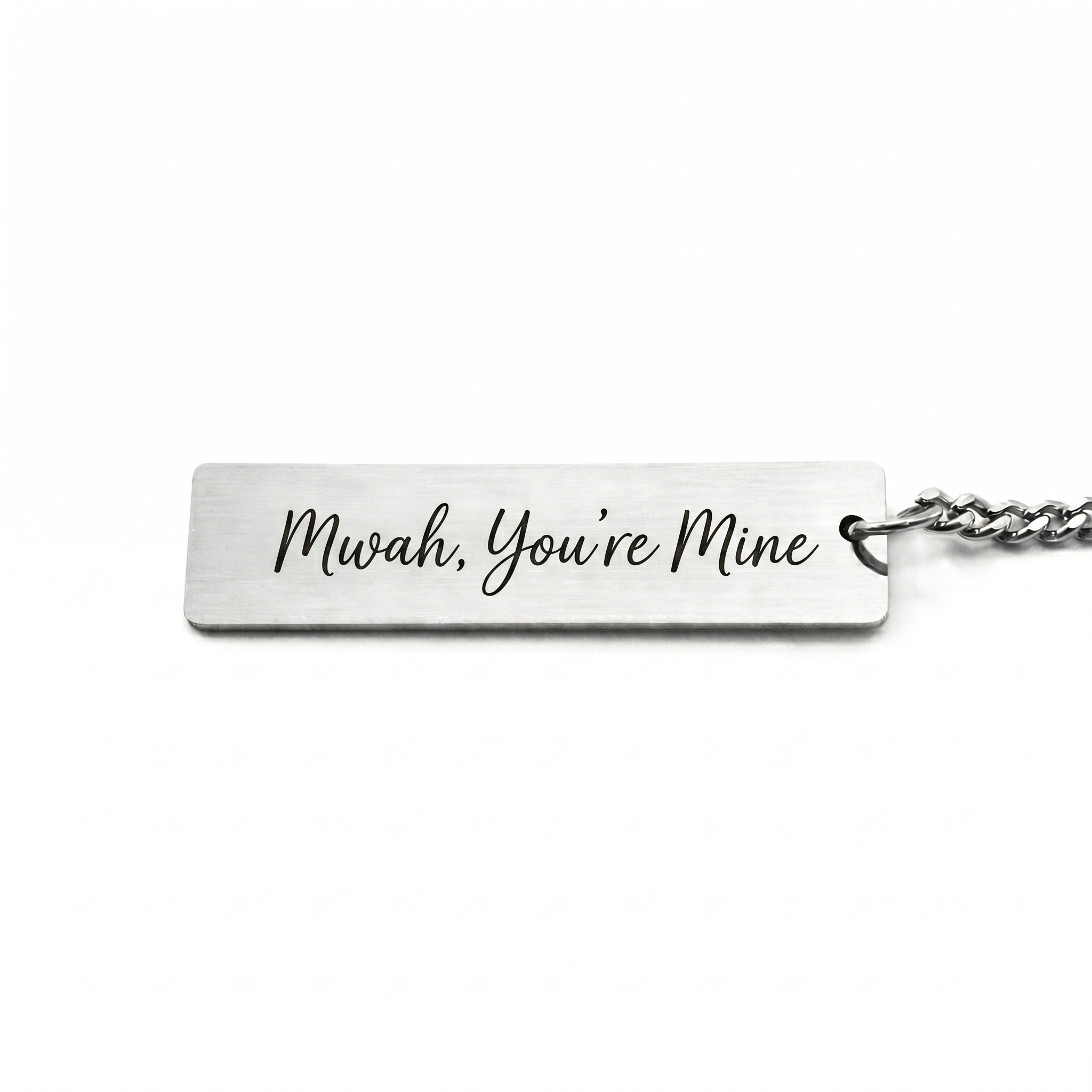 custom text on the back of a keychain in a casual script font that reads "mwah, you're mine"