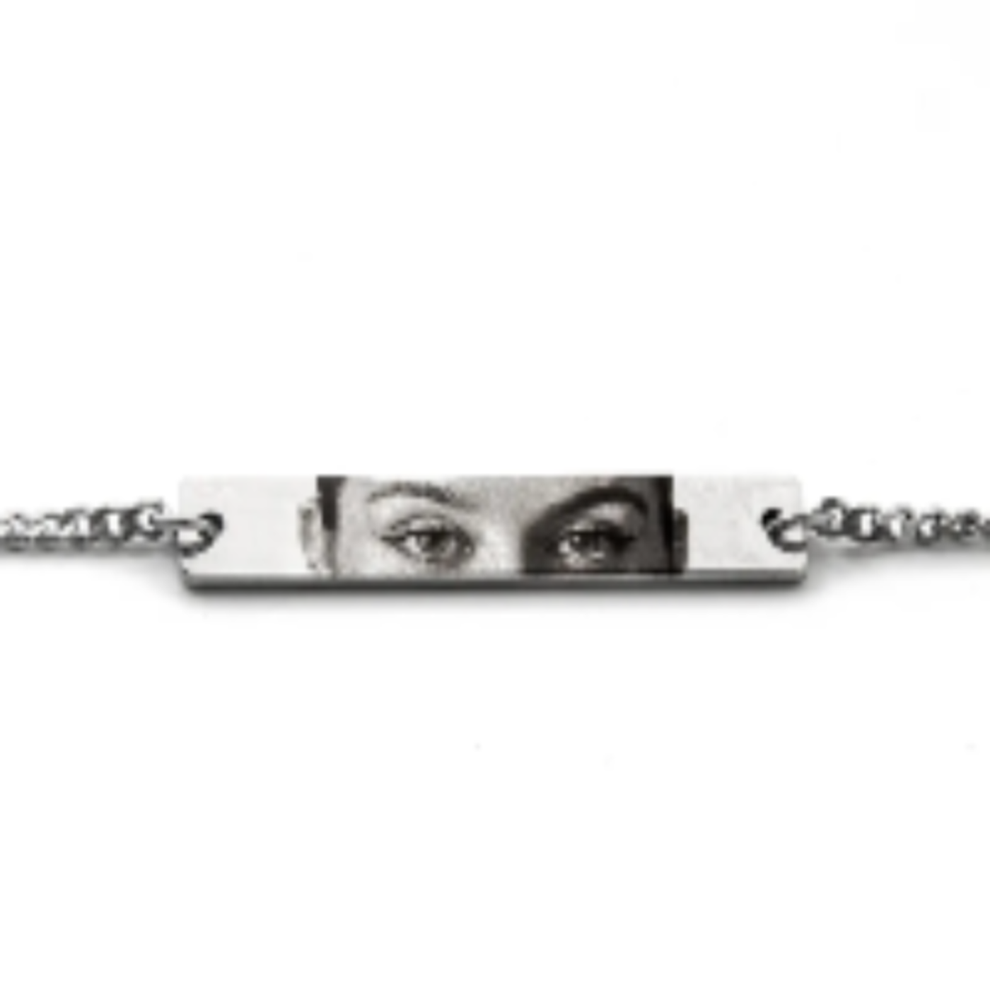 a silver bracelet pendant featuring a woman's eyes